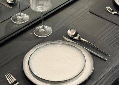 Elegant dining table setup with plates and wine glasses