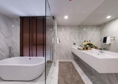 Modern bathroom with freestanding tub and large vanity mirror