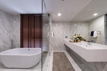 Modern bathroom with freestanding tub and large vanity mirror