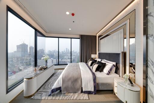 Modern bedroom with large windows and city view