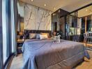 Modern bedroom with large bed, floor-to-ceiling windows, and stylish decor