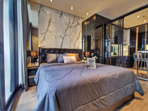 Modern bedroom with large bed, floor-to-ceiling windows, and stylish decor