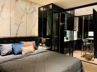 Modern bedroom with marble wall accent and mirrored closet doors