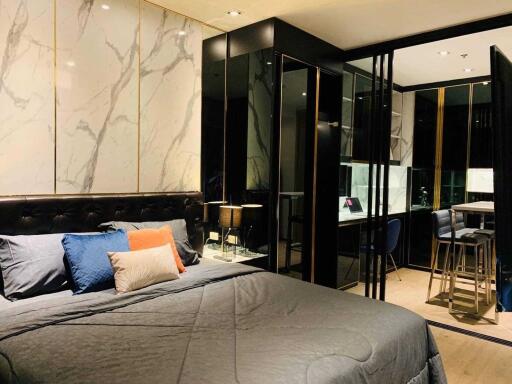 Modern bedroom with marble wall accent and mirrored closet doors