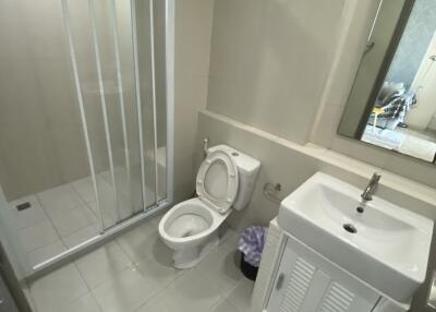 Modern bathroom with shower, toilet, and sink