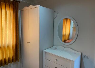 Bedroom with wardrobe, dresser, and mirror