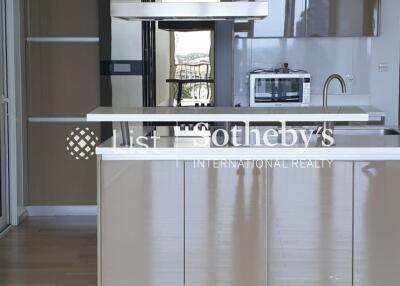 Modern kitchen area with built-in cabinets and appliances