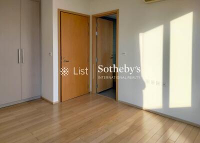 Bright bedroom with wooden flooring and built-in wardrobe