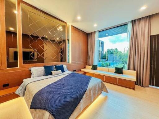 Modern bedroom with large window and stylish decor