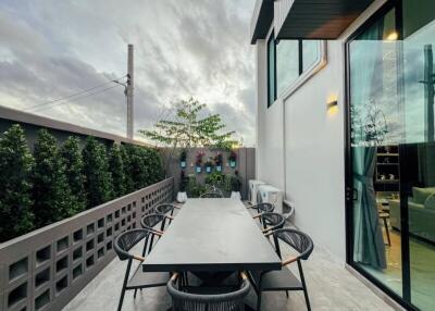 Outdoor dining area with a large table and chairs