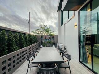 Outdoor dining area with a large table and chairs