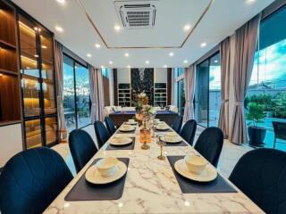 Elegant dining room with large windows and modern decor