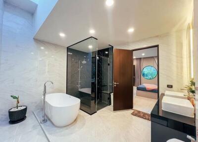 Modern bathroom with glass shower and freestanding bathtub