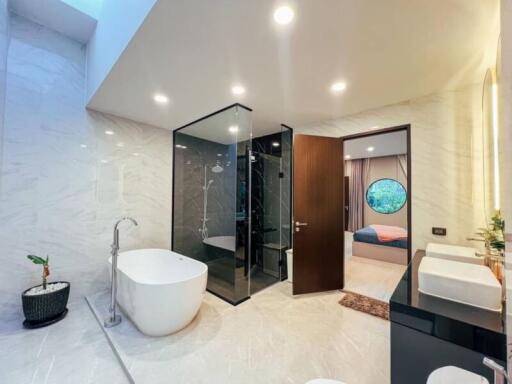 Modern bathroom with glass shower and freestanding bathtub