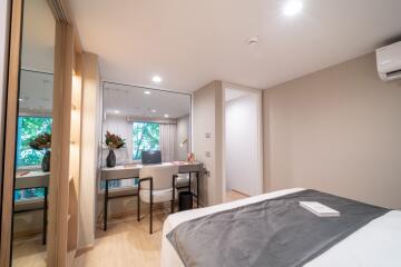 Modern bedroom with desk and mirror closet