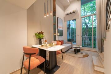 Modern living and dining area with high ceiling and natural light