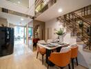 Modern dining area with table set for four and staircase