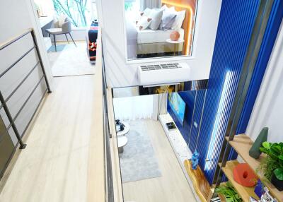 Modern duplex living space with a view of a bedroom through an interior window