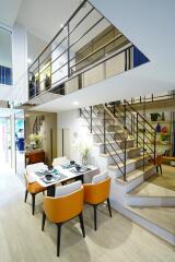 Modern dining area with a staircase and open balcony