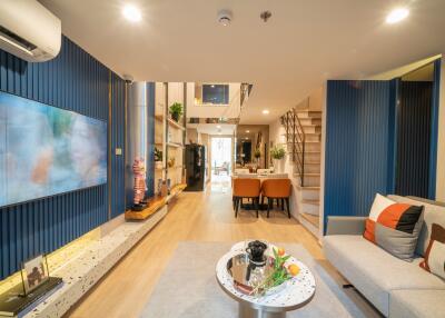 Spacious modern living room with dining area and staircase