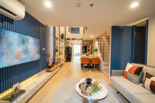 Spacious modern living room with dining area and staircase