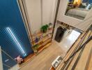 Contemporary multi-level living area with shelving and view into bedroom