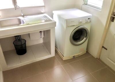 Laundry room with washing machine and sink