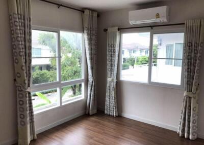 Bright bedroom with large windows and air conditioning