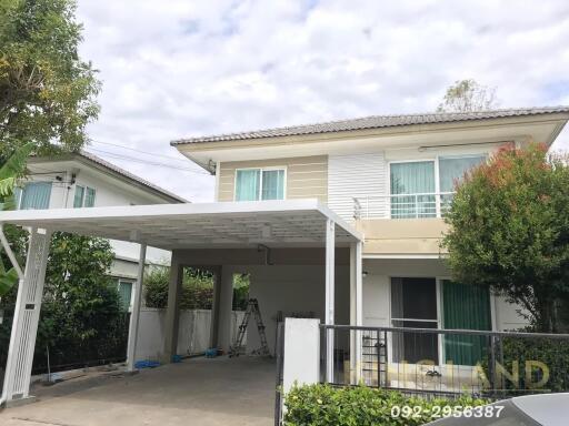 Two-story house with carport