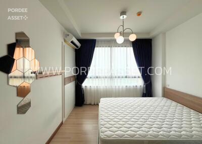 Modern bedroom with bed, window, and wall art