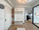 Main living area with white shelves and mirror