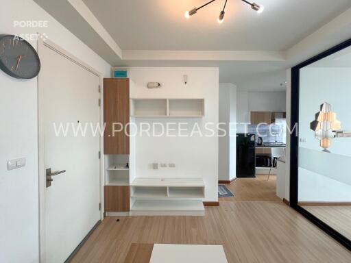 Main living area with white shelves and mirror