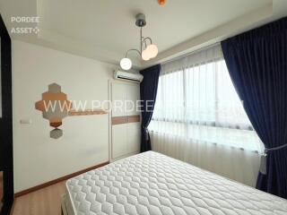 Bedroom with bed, window, and air conditioning unit