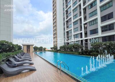 Outdoor swimming pool area with lounge chairs at residential building