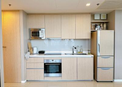 Modern kitchen with built-in appliances and wooden cabinetry