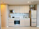 Modern kitchen with built-in appliances and wooden cabinetry