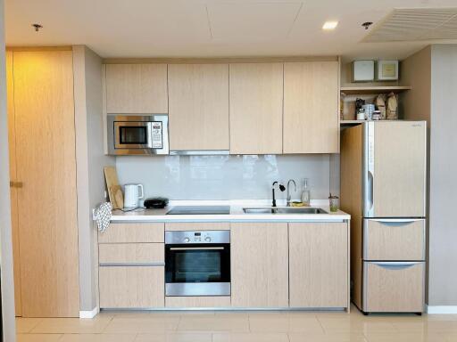 Modern kitchen with built-in appliances and wooden cabinetry