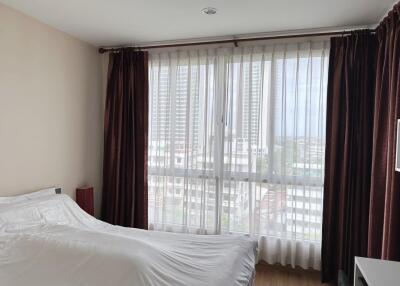 Bedroom with large window and curtains