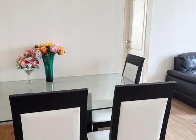 Dining area with glass table and black and white chairs