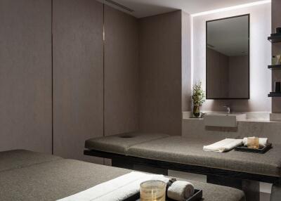 Spa room with two massage beds and a sink