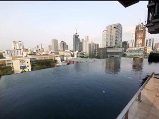 View of an infinity pool with a cityscape backdrop