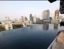 View of an infinity pool with a cityscape backdrop