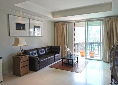 Spacious living room with modern decor and balcony view