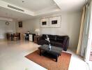 Spacious and modern living room with dining area and natural lighting