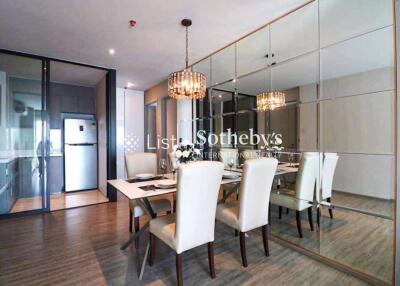 Elegant dining room with mirrored wall and chandelier