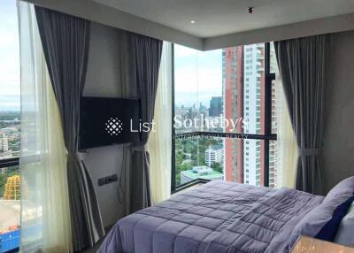 Bedroom with large windows and city view