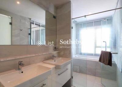 Modern bathroom with double sinks and bathtub