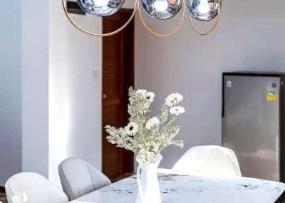 Modern dining area with stylish pendant lights and a minimalist table setting