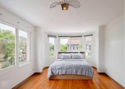 Spacious bedroom with large windows and wooden floors