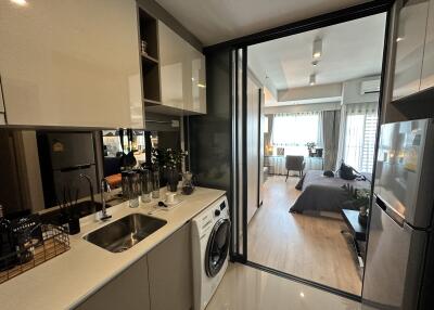 Modern apartment with a view into the bedroom from the kitchen